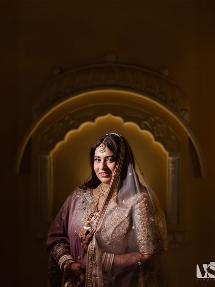 A close-up portrait of Sonal, beautifully lit to create a soft, glowing effect. Her gentle smile and the intricate details of her attire are the focus of this stunning shot.