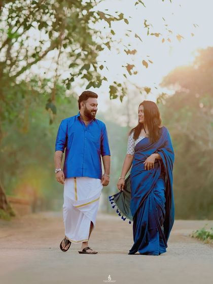 A candid walking shot, capturing a natural moment of conversation and laughter. The backlighting from the sun adds a beautiful, warm glow.