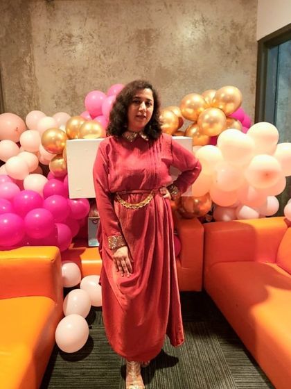 A client looking fabulous in a draped fusion dress. The hand-embroidered collar and cuffs elevate this piece.