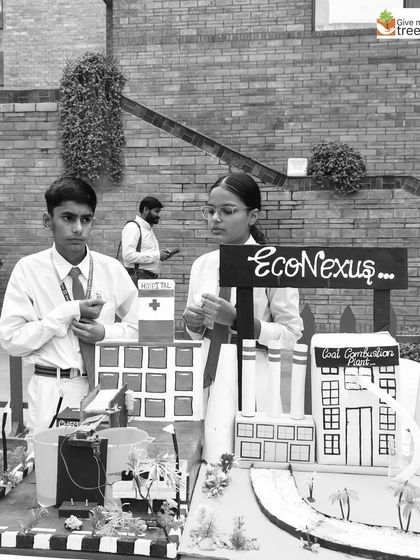 Students explain their "Eco Nexus" model, which demonstrates solutions for pollution and sustainable energy. Their passion and knowledge are truly impressive.