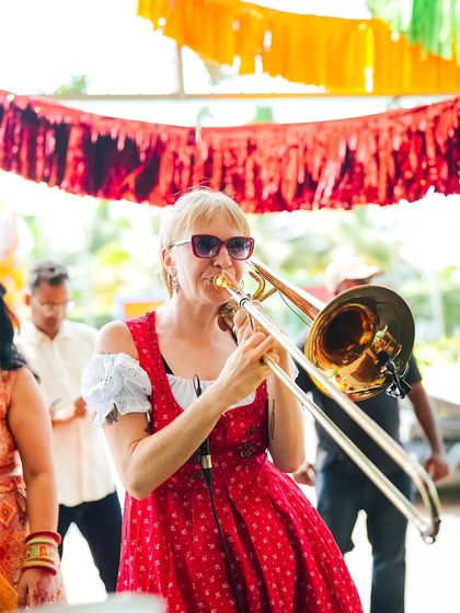 A live marching band, complete with a trombonist, weaves through the crowd, creating a dynamic and interactive musical experience. This is a huge step up from a stationary stage performance.