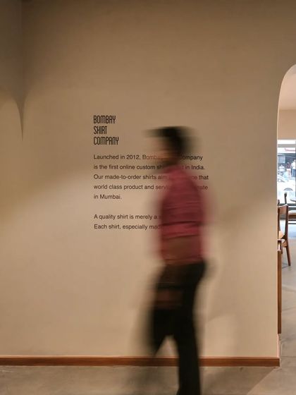 A motion-blurred shot capturing the dynamic yet calm atmosphere of the Bombay Shirt Company store.