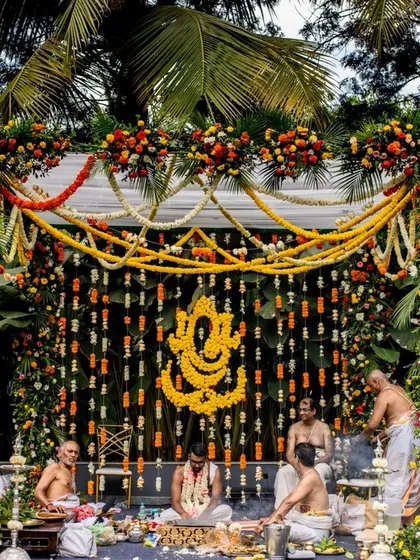 For this traditional Hindu wedding, we designed a magnificent mandap featuring a Ganesha motif made entirely of marigolds, surrounded by lush floral garlands to create a sacred and vibrant space.