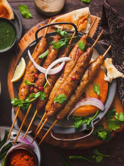 Smoky and spiced Veg Seekh Kebabs, grilled to perfection and garnished with fresh mint and pomegranate. A delicious vegetarian option packed with flavour.