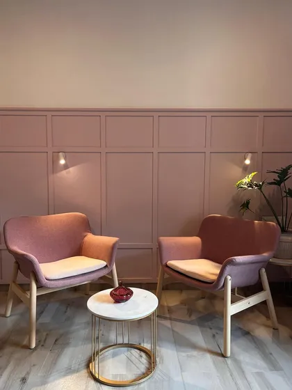 We created this cozy seating corner within a bedroom using a paneled accent wall and comfortable armchairs. It’s the perfect spot for reading a book or enjoying a quiet cup of tea.