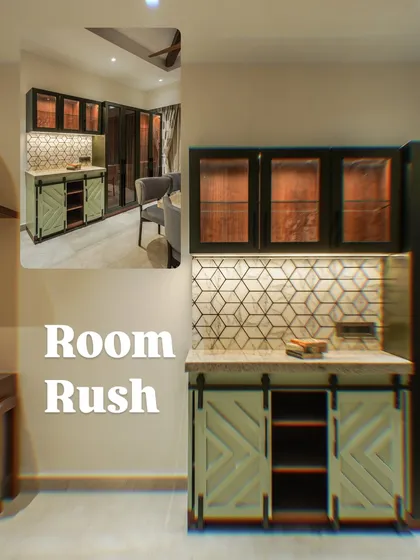 A close-up of a crockery unit with barn-style doors, set against a wall with a Madhubani art piece.