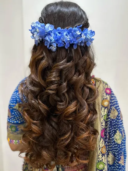 The back view of the hydrangea-adorned hairstyle, showing the beautiful contrast of colors.