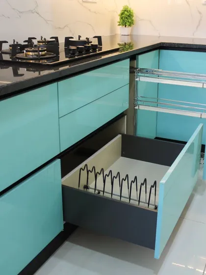 We believe in beauty that is also practical. This image showcases our smart storage solutions, including a multi-tiered pull-out spice rack and a deep drawer with a custom plate organizer, ensuring everything has its place.