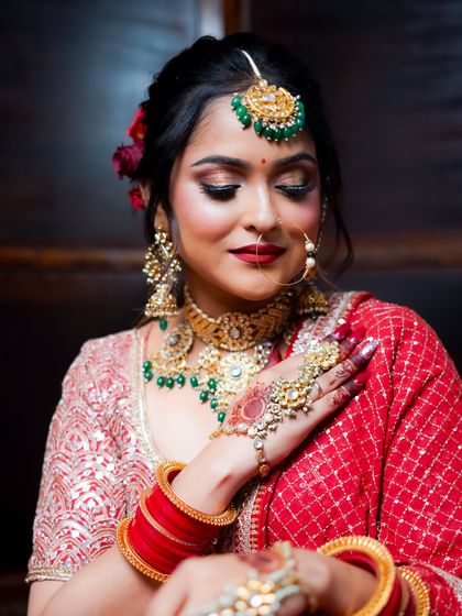 This portrait captures the bride's soft smile and the timeless beauty of her makeup and jewelry.