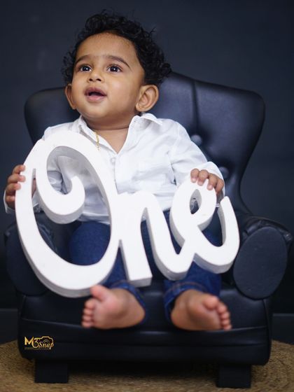 Another classic "ONE" portrait. His curious expression and tiny bare feet make this shot extra adorable.