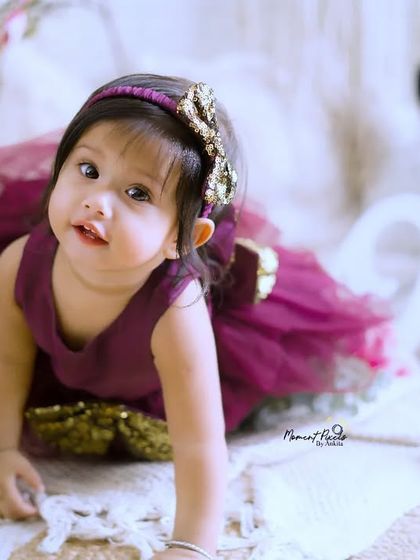 A curious little crawler in a beautiful dress. This photo captures that exciting milestone when babies start to explore the world on their own.