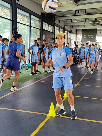 A header challenge during a team warm-up. This drill improves reaction time, proprioception, and aerial ball skills in a fun, competitive setting. It's about making athletes better while keeping them engaged.