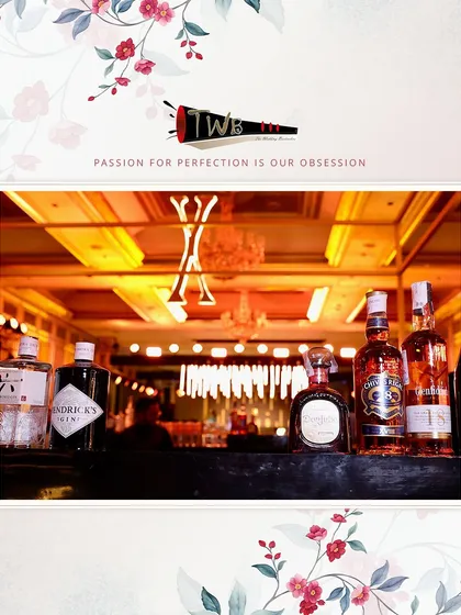 A sophisticated bar display showcasing a premium selection of gins and whiskies against an elegantly lit backdrop for a corporate anniversary event.