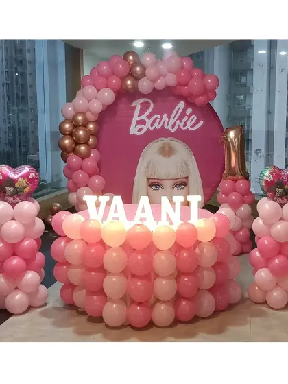 The full Barbie setup, including the main backdrop and two matching balloon pillars with heart-shaped foil balloons.