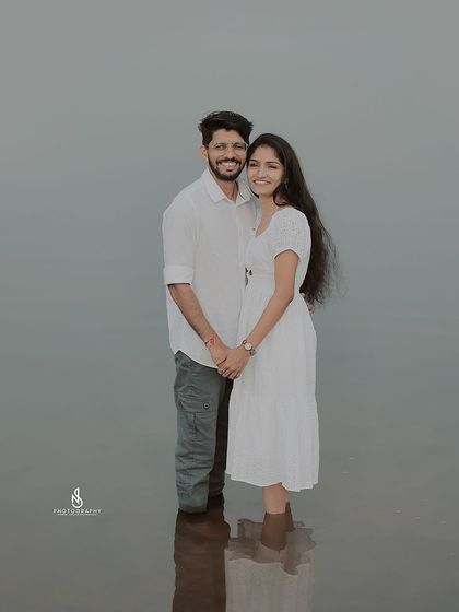A simple, elegant portrait of the couple standing in the water, with their reflection creating a beautiful effect.