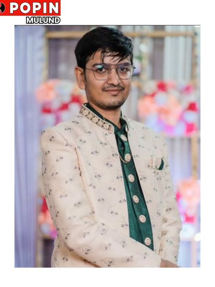 A happy client wearing one of our Indo-Western style sherwanis. The printed jacket is paired with a contrasting green silk kurta, creating a stylish look for any wedding event.