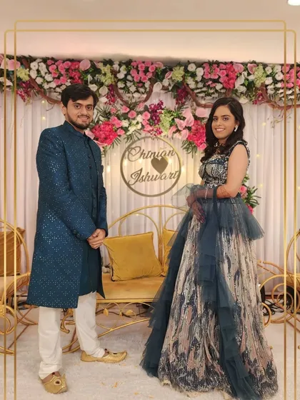 This couple opted for a bold and contemporary look. The groom's sequined teal sherwani is a showstopper, beautifully paired with the bride's modern, abstract-print gown.