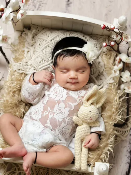 This sweet baby is smiling in her sleep. We are always ready to capture these fleeting, magical moments.