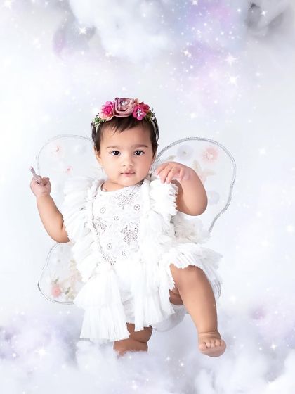 A little magic everywhere you go. This sweet fairy with a floral headband and delicate wings looks absolutely ethereal against a sparkling, cloud-filled backdrop.