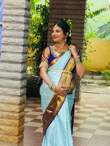 The beautiful mom-to-be, glowing for her Semantha (baby shower) ceremony. I created this traditional South Indian look with a focus on radiant skin, a classic red lip, and an elegant messy bun to celebrate this precious milestone.