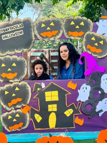 A vampire and his mom enjoying our Halloween event. We believe in creating a strong community by involving parents in our celebrations.