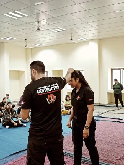 Learning is a hands-on process. In our classes, I provide personal guidance on every technique, like this defense against a head grab, ensuring you understand the mechanics and can execute them effectively when it matters most.