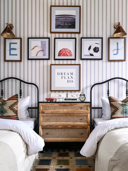Designing for kids is about capturing their personality. For this shared boys' bedroom, I mixed a classic Spanish theme with fun, personal touches. The gallery wall features their initials and favorite sports, creating a space that is both stylish and uniquely theirs.
