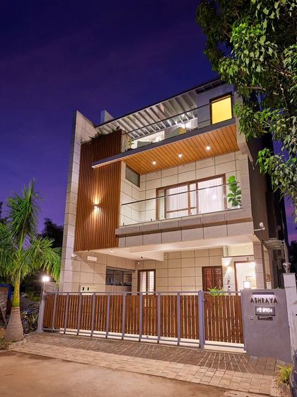 The recently completed villa in Odion Woods of the East, photographed at dusk. Built on a compact 30x60 plot, the floors are recessed at each level to reduce the building's perceived scale from the street.