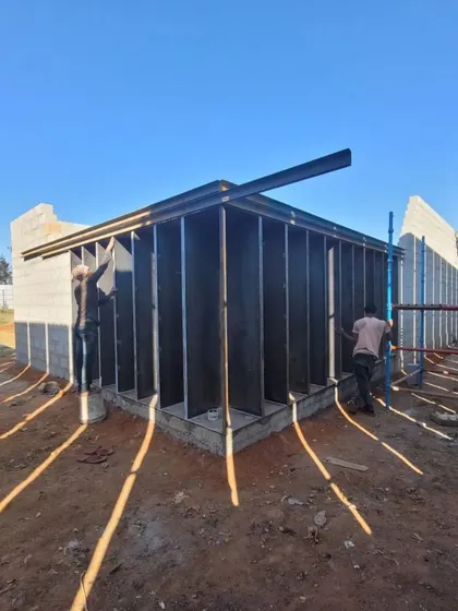 This image captures the hands-on process of construction. The steel frame and blockwork show the honest, exposed material palette I often favor in my designs.