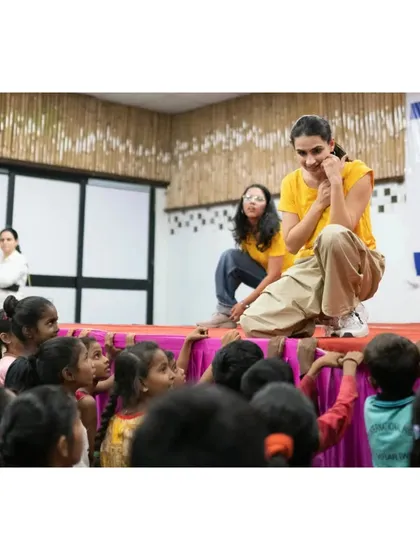 Interacting with the kids up close. This photo shows me on the edge of the stage, sharing a fun moment and making a personal connection with the children.