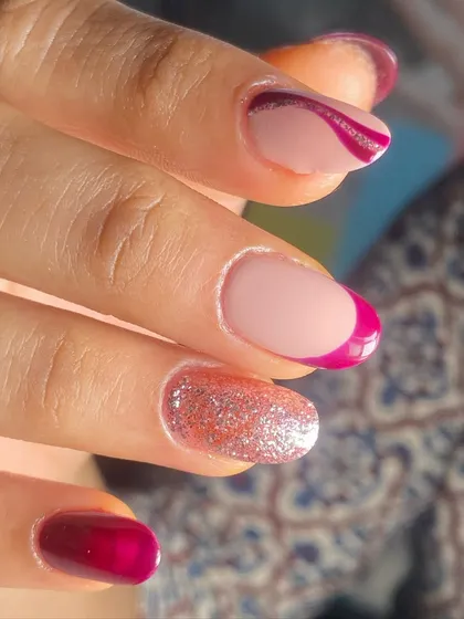 A glamorous French manicure with a magenta tip and a sparkling glitter accent nail.