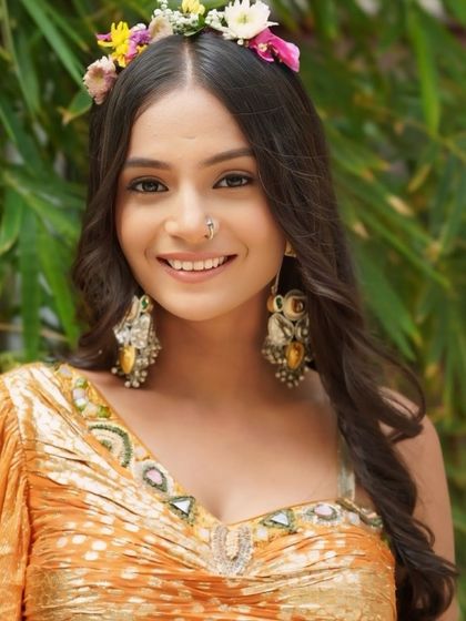 A close up on the Haldi bride's face, highlighting the natural, minimal makeup and the delicate nose ring.