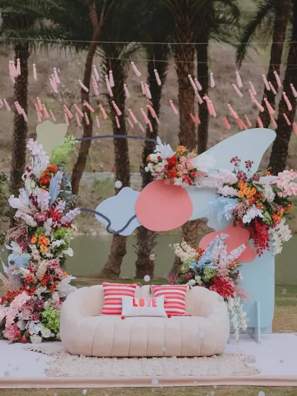 A photo backdrop from a sunny, Coachella-inspired soirée. We used abstract shapes, a soft pastel palette, and lush florals to create a playful and modern focal point that perfectly captured the event's cheerful vibe.