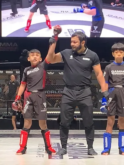 The moment of victory. Shivam's hand is raised after winning his semi-final match, securing his spot in the world championship final.