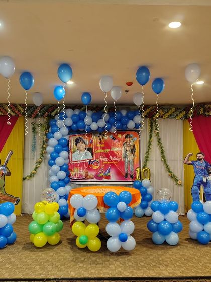 For this cricket-themed birthday party, I used cricketer cutouts, a custom photo backdrop, and balloon pillars in team colors. It's a great choice for any young sports fan.