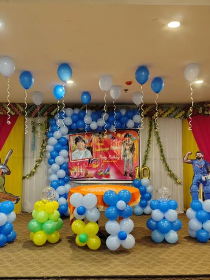 For this cricket-themed birthday party, I used cricketer cutouts, a custom photo backdrop, and balloon pillars in team colors. It's a great choice for any young sports fan.