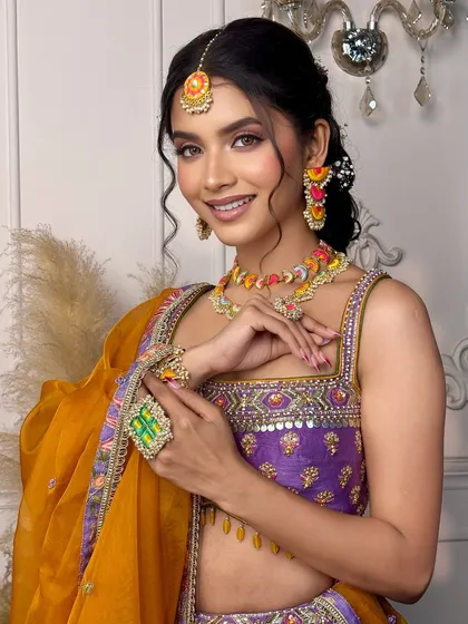 This shot highlights the unique jewelry and the pop of purple under the eyes in the 'Khushnuma' look. It's all about adding a touch of personality to the bridal glam.