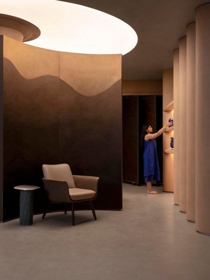 A visitor interacts with the display, highlighting the space's function as a tactile and engaging showroom for materials and products.