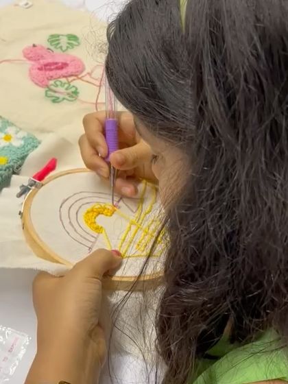 A young crafter carefully punching a bright yellow rainbow design. I make sure everyone, including kids, gets the hang of the technique and has fun with it.