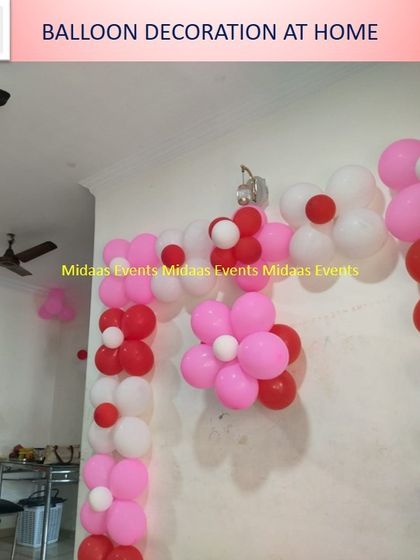 Another angle of the pink, red, and white balloon flower arch, creating a lovely frame for a cake table or entrance at home.
