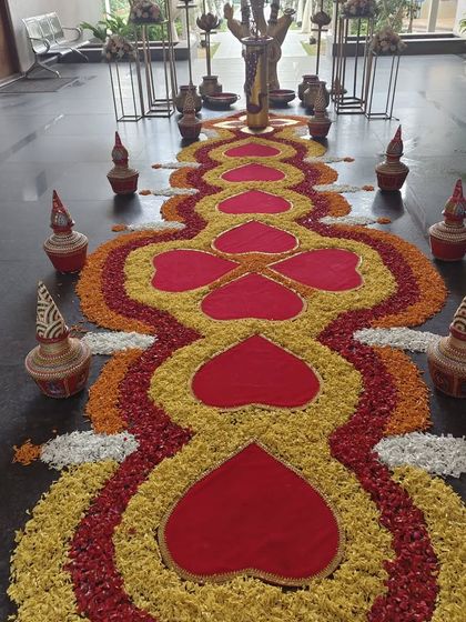 A beautiful floral rangoli or 'pookalam' designed for a welcome entry. This intricate pattern of flower petals creates a stunning and traditional greeting.