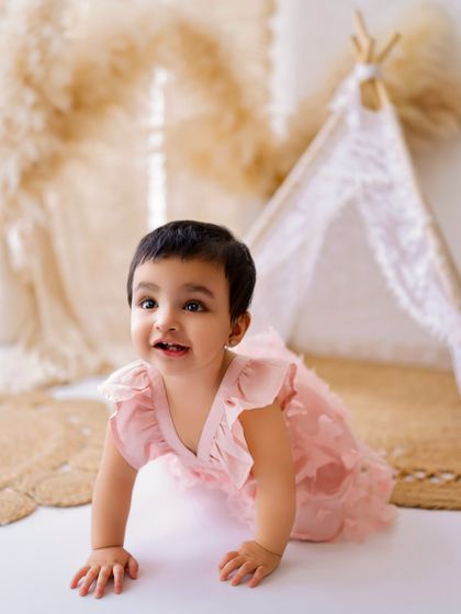 On the move! Capturing babies as they start to crawl and explore is a key part of my milestone sessions. This little one is dressed in a lovely pink outfit.