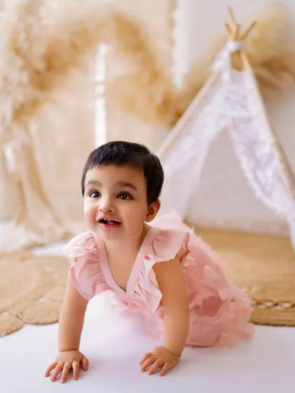 On the move! Capturing babies as they start to crawl and explore is a key part of my milestone sessions. This little one is dressed in a lovely pink outfit.