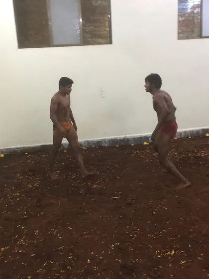 The first moments of a bout during our akhada's opening ceremony. The stance and initial engagement are crucial in setting the tone for the match in mud wrestling.