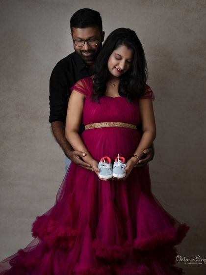 A beautiful pose focusing on the tiny shoes and the baby bump. It’s a sweet symbol of the new life they are about to welcome.