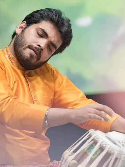 A moment of deep concentration during a performance at the Malhar Festival. Tuning the tabla on stage is a critical skill, ensuring the drums are perfectly pitched for the raga being presented.