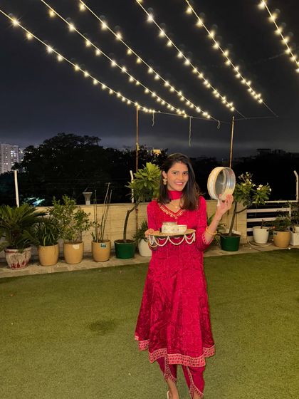A full-length view of my Karwa Chauth outfit. The rich red velvet fabric and intricate gold embroidery of the anarkali make it a perfect choice for a festive evening.