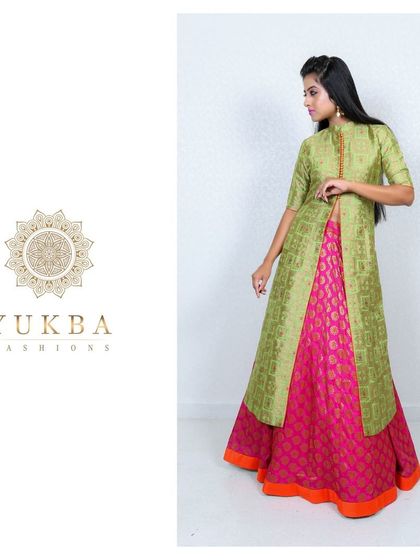 A modern interpretation of traditional wear. This outfit features a pink brocade skirt paired with a long green jacket-style top, creating a chic and layered look for any celebration.