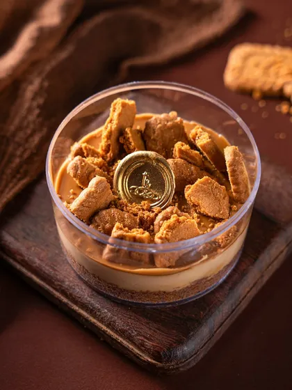 The Biscoff Cheesecake tub, a fan favorite. I layer creamy cheesecake over a spiced biscuit base and top it with crunchy Biscoff crumbles for a perfect balance of texture and flavor.