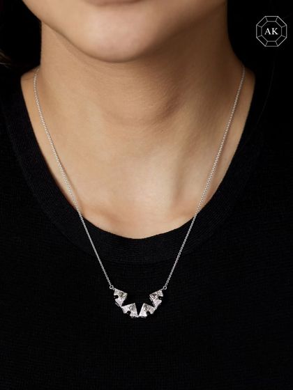 This versatile diamond pendant transforms effortlessly. Here, it is opened out into a longer, striking design, held by hidden magnets.